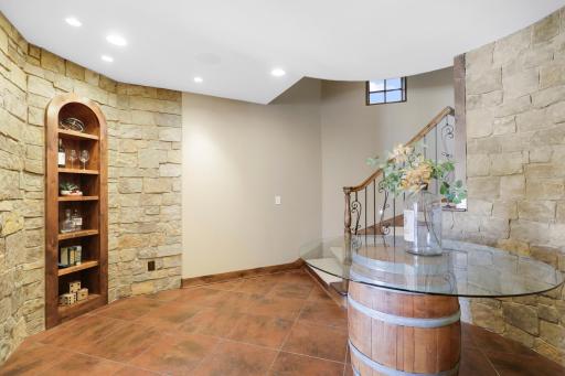 The walkout lower level is set for entertaining lake guests, boasting a fully equipped bar attached to the media room, a climate-controlled wine room, a tasting room, a 5th bedroom, additional storage, and a lake storage room with a 2nd laundry.