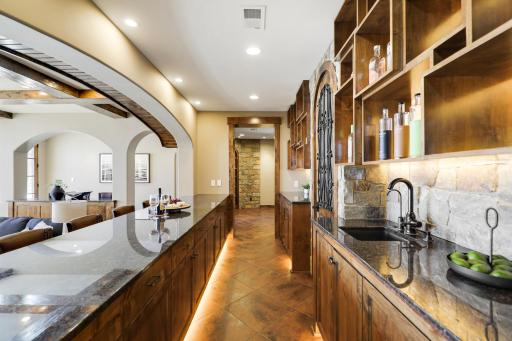 The walkout lower level is set for entertaining lake guests, boasting a fully equipped bar attached to the media room, a climate-controlled wine room, a tasting room, a 5th bedroom, additional storage, and a lake storage room with a 2nd laundry.