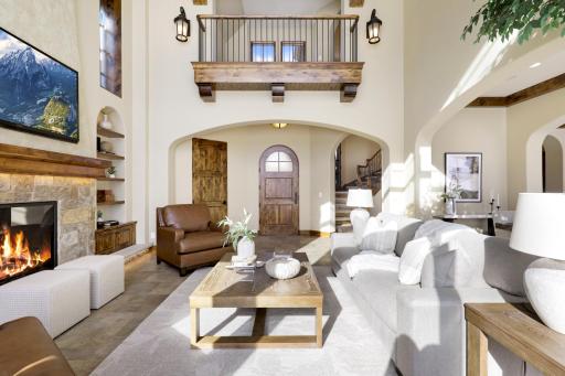 High-end finishes/features include a bright, open floorplan, massive ceiling vaults, heated porcelain tile floors, 8â doors, rounded archways, extensive knotty alder millwork, magnificent stonework, and so much more.