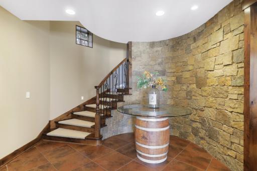The walkout lower level is set for entertaining lake guests, boasting a fully equipped bar attached to the media room, a climate-controlled wine room, a tasting room, a 5th bedroom, additional storage, and a lake storage room with a 2nd laundry.