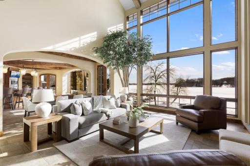 Natural daylight floods the main floor through the SE facing wall of floor-to-ceiling windows from dawn until early afternoon, making way for cooling shade from afternoon to dusk.