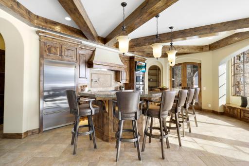 Experience expansive views of Smithtown Bay while cooking in your opulent chefâs kitchen, featuring Wolf and Sub-Zero appliances, natural stone countertops, and a walk-in pantry.