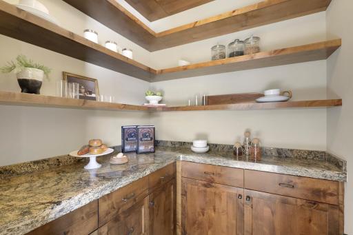 Experience expansive views of Smithtown Bay while cooking in your opulent chefâs kitchen, featuring Wolf and Sub-Zero appliances, natural stone countertops, and a walk-in pantry.