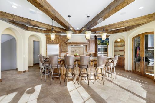 Experience expansive views of Smithtown Bay while cooking in your opulent chefâs kitchen, featuring Wolf and Sub-Zero appliances, natural stone countertops, and a walk-in pantry.