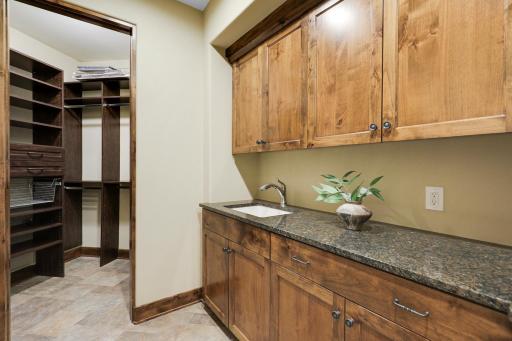 The mud room connects to the garage and kitchen, and features a large sink, plenty of cabinet storage and a large walk-in closet.