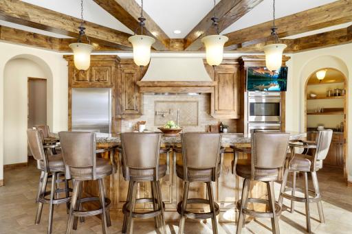 Experience expansive views of Smithtown Bay while cooking in your opulent chefâs kitchen, featuring Wolf and Sub-Zero appliances, natural stone countertops, and a walk-in pantry.