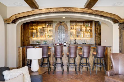 The walkout lower level is set for entertaining lake guests, boasting a fully equipped bar attached to the media room, a climate-controlled wine room, a tasting room, a 5th bedroom, additional storage, and a lake storage room with a 2nd laundry.