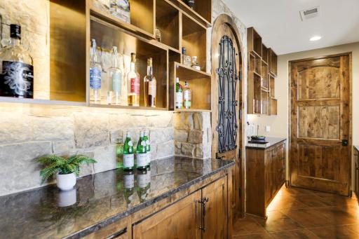 The walkout lower level is set for entertaining lake guests, boasting a fully equipped bar attached to the media room, a climate-controlled wine room, a tasting room, a 5th bedroom, additional storage, and a lake storage room with a 2nd laundry.