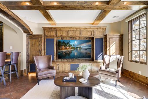 The walkout lower level is set for entertaining lake guests, boasting a fully equipped bar attached to the media room, a climate-controlled wine room, a tasting room, a 5th bedroom, additional storage, and a lake storage room with a 2nd laundry.