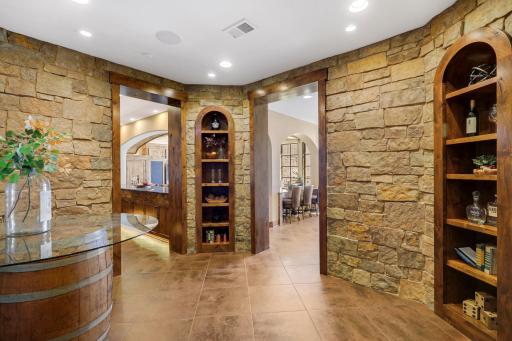 The walkout lower level is set for entertaining lake guests, boasting a fully equipped bar attached to the media room, a climate-controlled wine room, a tasting room, a 5th bedroom, additional storage, and a lake storage room with a 2nd laundry.