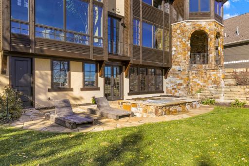A generously sized, inground hot tub on the lower patio boasts decorative lighting and water features providing the perfect place to unwind after a long day on the lake.