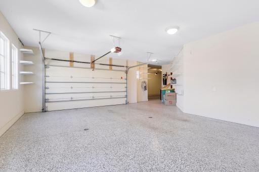 The oversized 3-car garage features epoxied floors with floor drains, a wash bay with hot and cold water, a central vacuum system, and plenty of room for additional storage.