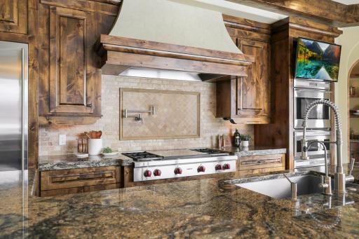 Experience expansive views of Smithtown Bay while cooking in your opulent chefâs kitchen, featuring Wolf and Sub-Zero appliances, natural stone countertops, and a walk-in pantry.