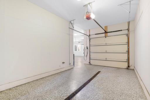 The oversized 3-car garage features epoxied floors with floor drains, a wash bay with hot and cold water, a central vacuum system, and plenty of room for additional storage.