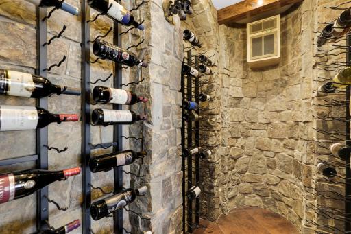 The walkout lower level is set for entertaining lake guests, boasting a fully equipped bar attached to the media room, a climate-controlled wine room, a tasting room, a 5th bedroom, additional storage, and a lake storage room with a 2nd laundry.