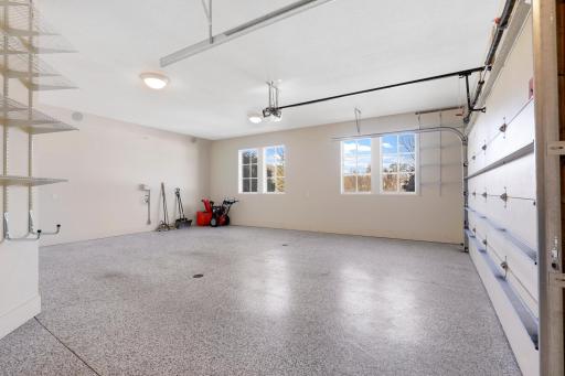The oversized 3-car garage features epoxied floors with floor drains, a wash bay with hot and cold water, a central vacuum system, and plenty of room for additional storage.