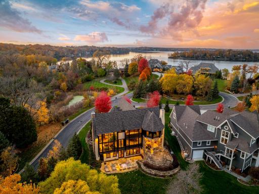 Natural stone retaining walls and strategically placed landscape lighting accentuate the architectural features of the home.