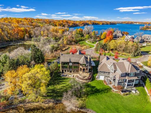 The almost perfectly flat backyard gently slopes to 133 feet of owned, southeast facing lakeshore on the crystal clear, A-rated waters of Smithtown Bay, Lake Minnetonka.