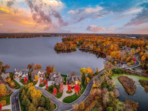 The almost perfectly flat backyard gently slopes to 133 feet of owned, southeast facing lakeshore on the crystal clear, A-rated waters of Smithtown Bay, Lake Minnetonka.