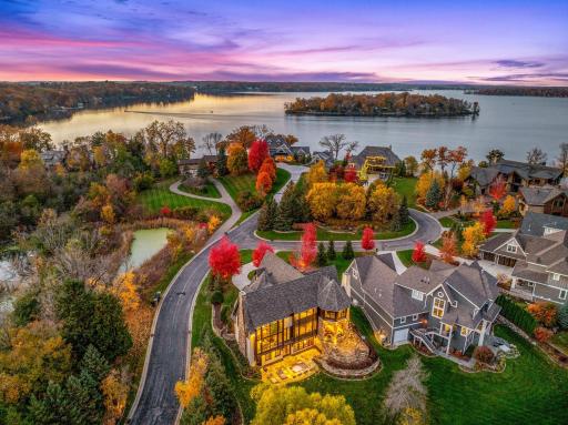 The almost perfectly flat backyard gently slopes to 133 feet of owned, southeast facing lakeshore on the crystal clear, A-rated waters of Smithtown Bay, Lake Minnetonka.