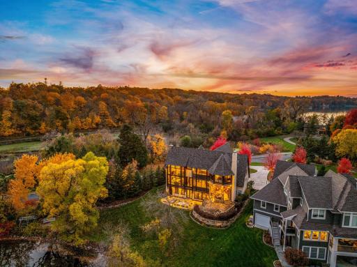 Natural stone retaining walls and strategically placed landscape lighting accentuate the architectural features of the home.