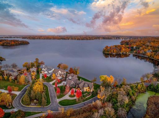 The almost perfectly flat backyard gently slopes to 133 feet of owned, southeast facing lakeshore on the crystal clear, A-rated waters of Smithtown Bay, Lake Minnetonka.