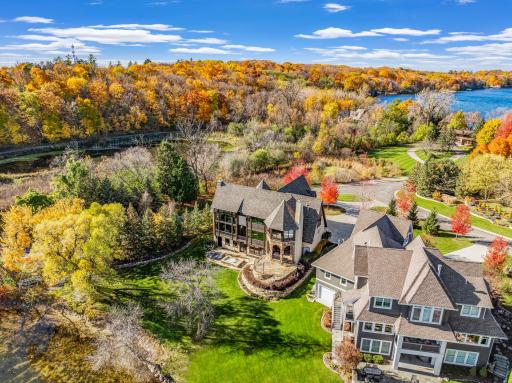 The almost perfectly flat backyard gently slopes to 133 feet of owned, southeast facing lakeshore on the crystal clear, A-rated waters of Smithtown Bay, Lake Minnetonka.