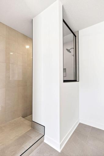 A luxe soaking tub and a separate shower contribute to a spa-like atmosphere