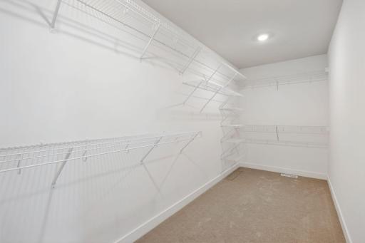 Expansive walk-in closet in owner's suite