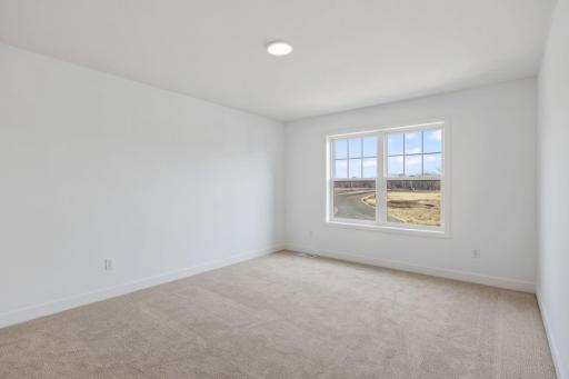 Situated on the second floor, this secondary bedroom features a walk-in closet offering ample space for wardrobe storage.