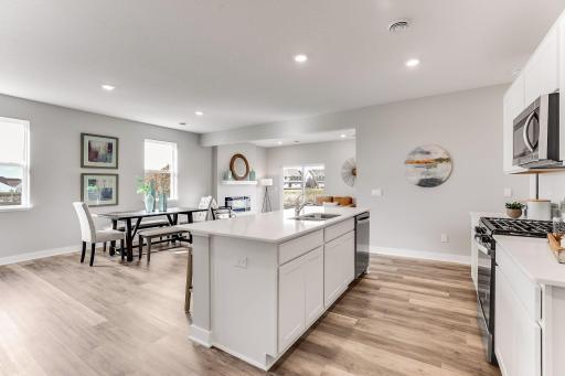 This open concept main level allows for ease in entertaining. Wonderful accessibility to the dining room and living room. *Photo is of a model home.