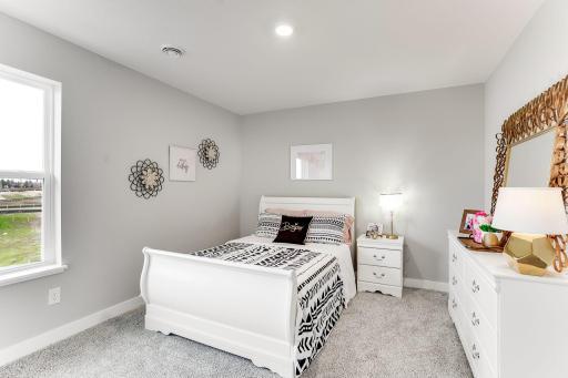 One of three, large, secondary bedrooms on the upper level. *Photo is of a model home