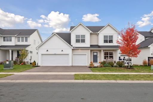 Stunning curb appeal with inviting front porch and spacious three-car garage.