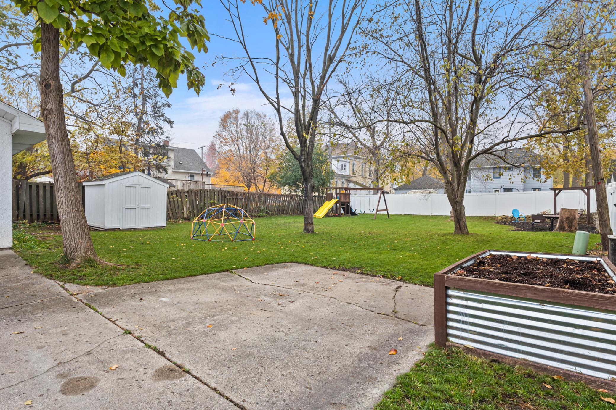 Backyard with Swingset, Garden Bed, & Shed