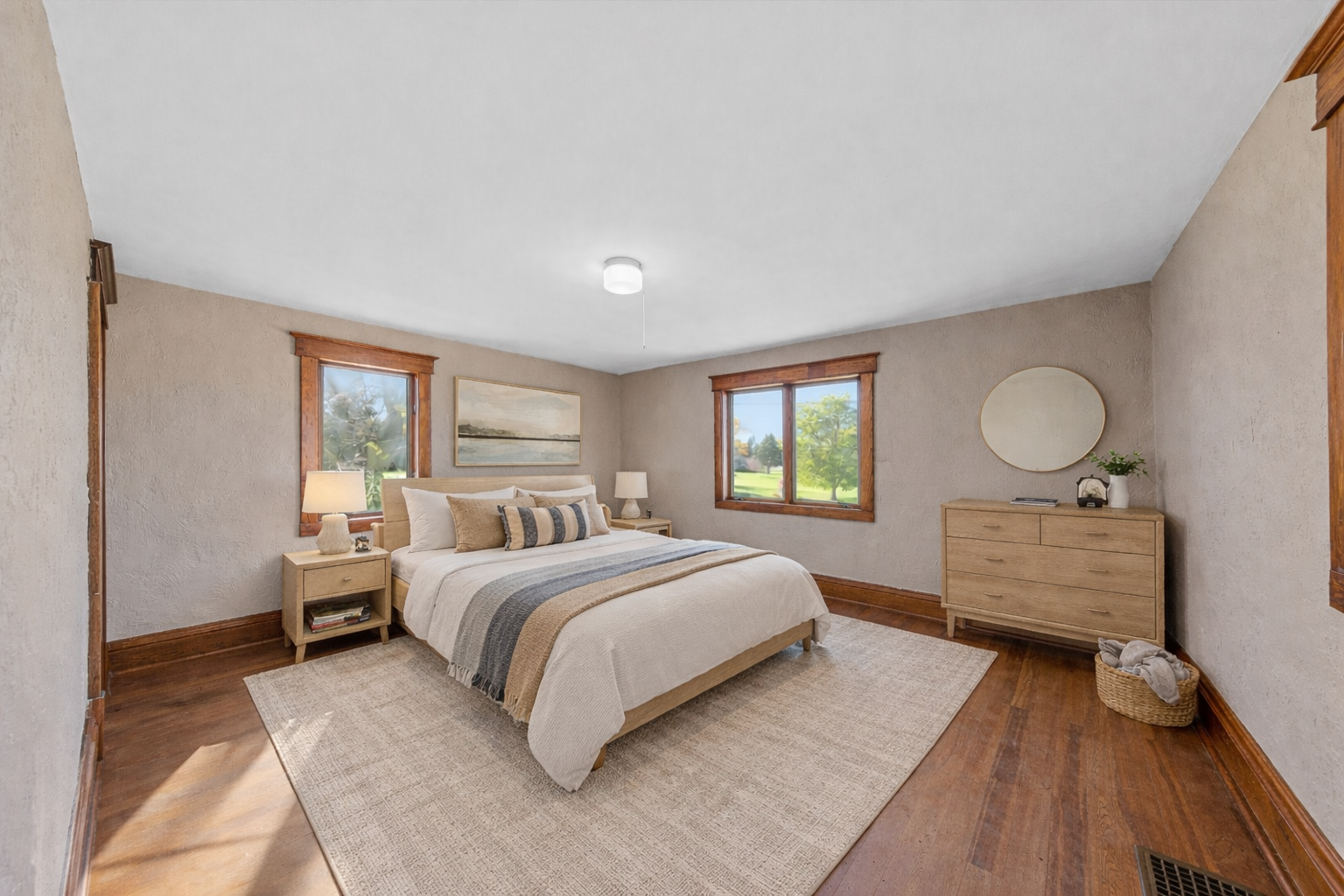 Spacious Primary Bedroom...virtually staged. All bedrooms up have hardwood flooring.