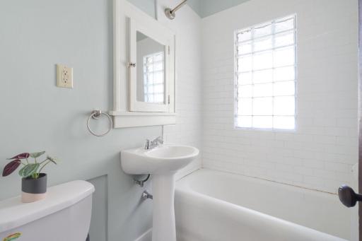 The updated bathroom features a charming pedestal sink, a tiled shower/tub, and other modern finishes youâll love.