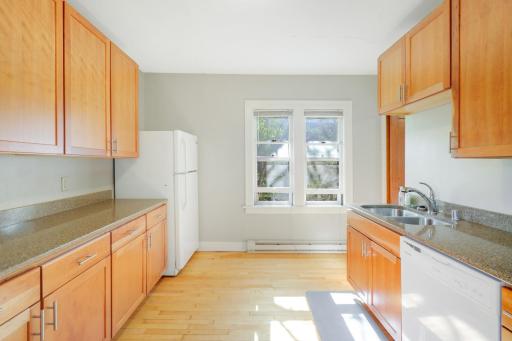Sunlight streams through the kitchen window, brightening the space.