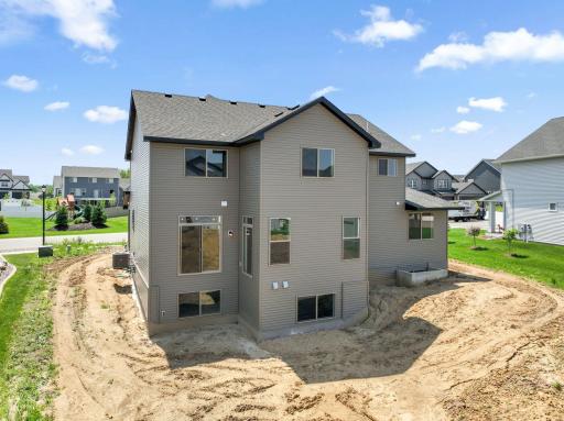Large yard with basement look-out windows.