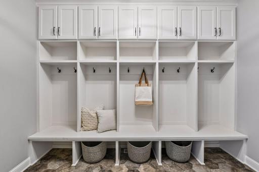 The mudroom off the garage entry has built-in lockers, a bench, and cubbies for one cohesive drop zone