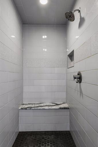 Primary bath features large soaking tub, tiled walk-in shower, dual vanities, and separate water closet