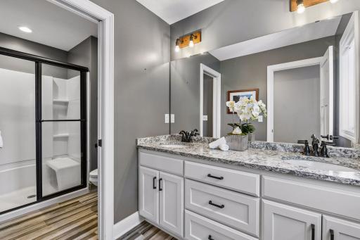 Third upper-level bath with dual comfort-height vanities and a separated shower and toilet, built so two people can get ready at the same time without waiting on each other.