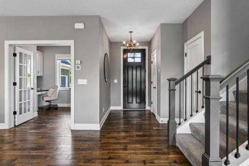 As you step inside the front entry you are greeted with wide-plank hardwood floors that carry through the main level.