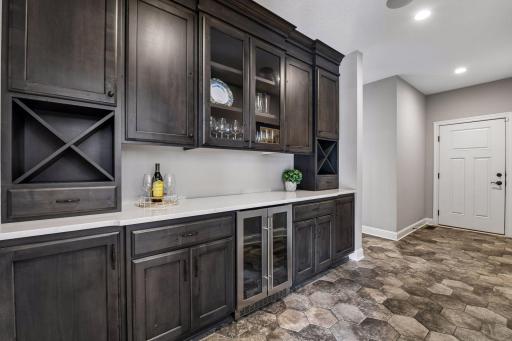 Just off the kitchen you will find custom built in bar and beverage fridge for entertaining