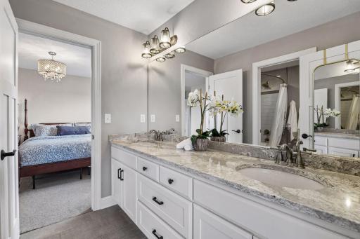 Jack and Jill bathroom has dual vanities and separate with separate space for shower
