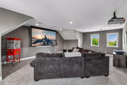 Upstairs loft is a fully outfitted theatre: projector, drop-down screen, and surround sound, ready for movie night.