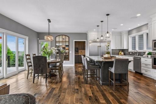 Open concept kitchen, dining room and sliders that open out to maintenance free deck