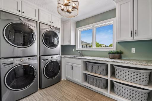Upstairs you will find large laundry room with two sets of washer dryers, utility sink, and large walk in closet