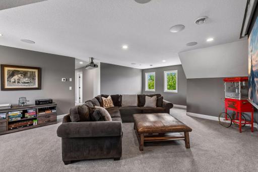 The loft is a fully outfitted theatre: projector, drop-down screen, and surround sound, ready for movie night.
