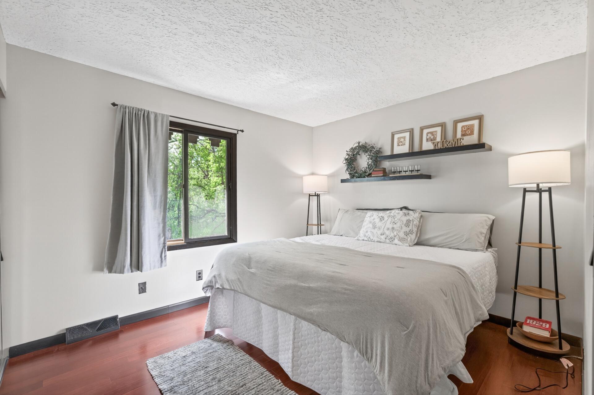 Primary bedroom on the ground floor has great, wooded views