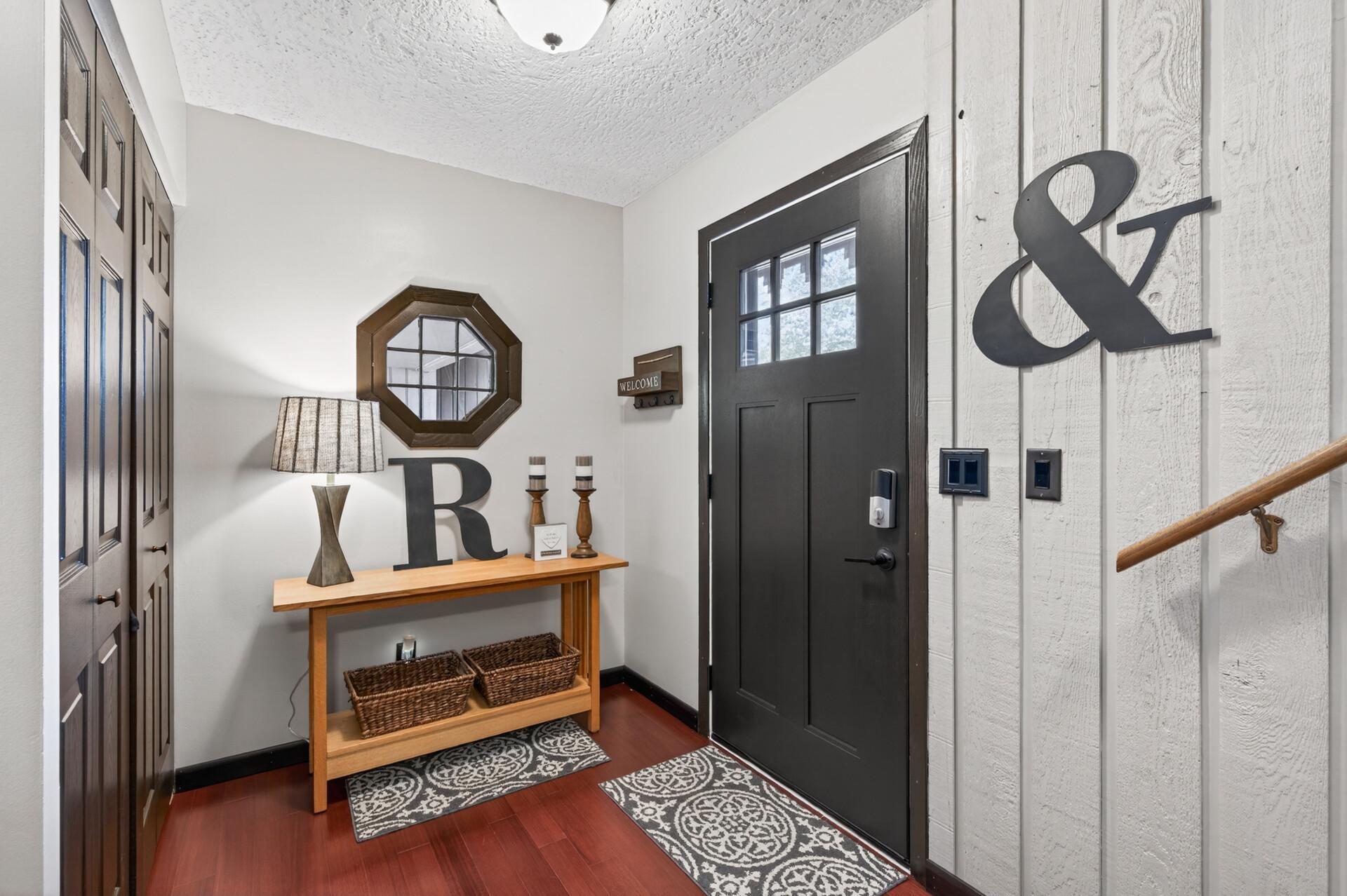 Front entry on the ground floor leads upstairs to kitchen, dining, and living room